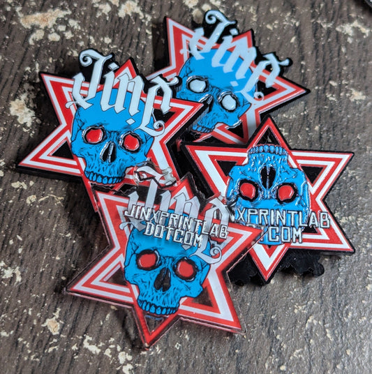 Six pointed star-shaped acrylic keychains with blue skull designs and red accents with textured UV prints